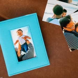 A teal linen album on a table