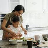 A parent and child baking together